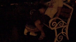 Young Couple Enjoys Intimate Moments on Roadside Bench